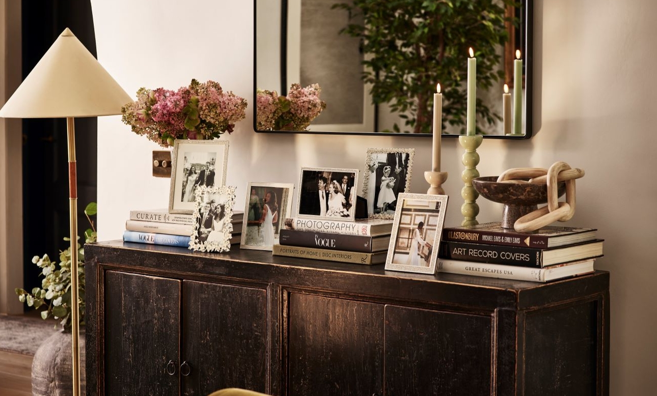 sideboard at home with lots of photo frames on