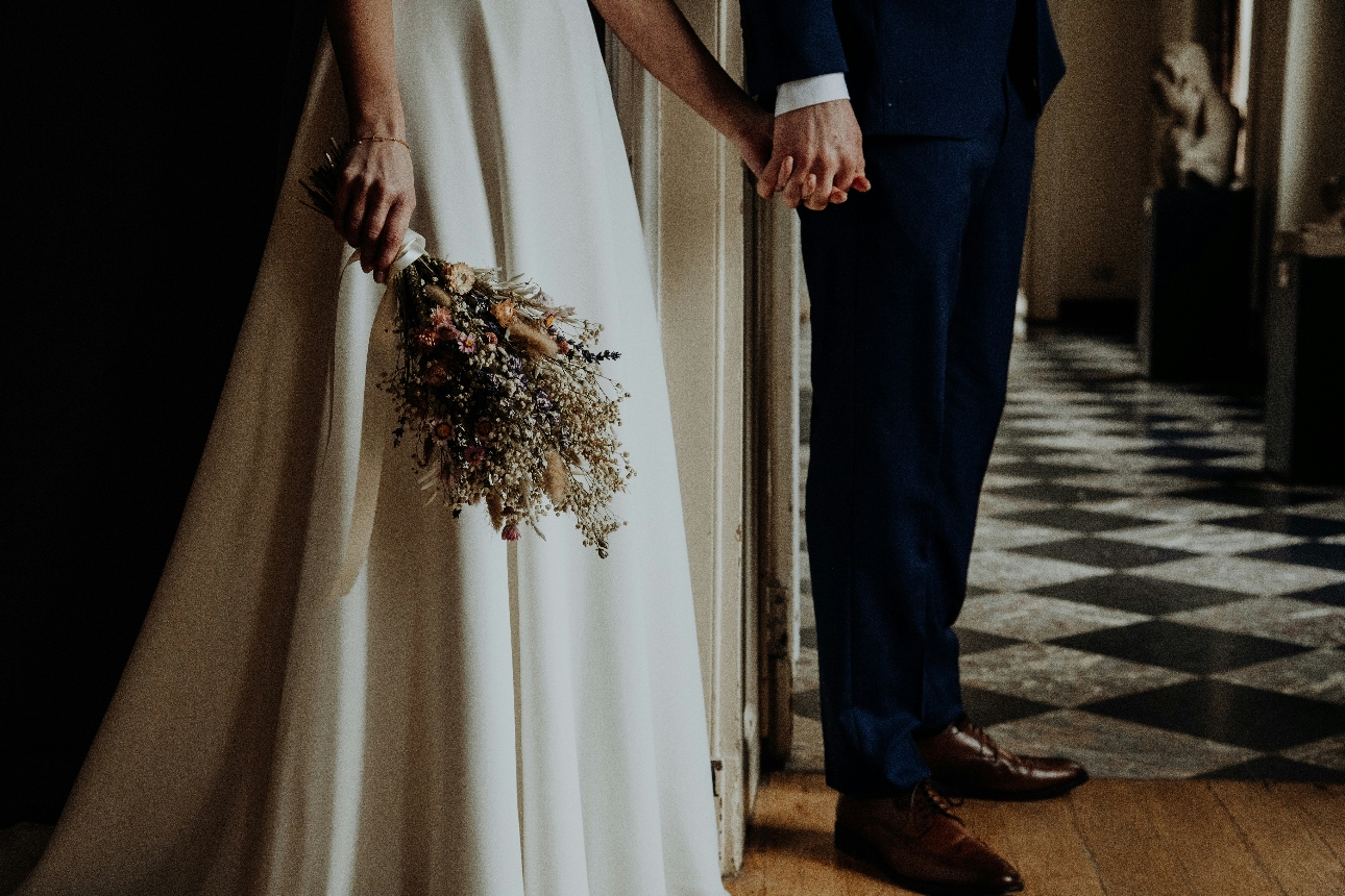 couple holding hands at wedding